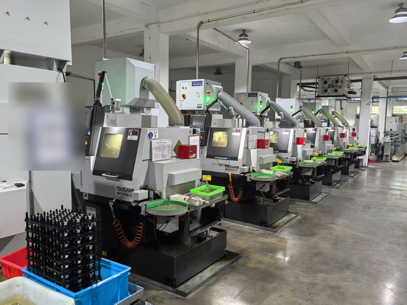 A row of Tsugami B0205-V Swiss-type lathes running in production